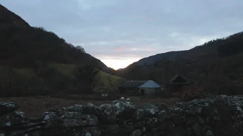 Slightly moving handheld shot looking at sunset in a triangular mountain shape Stock Footage 101759529