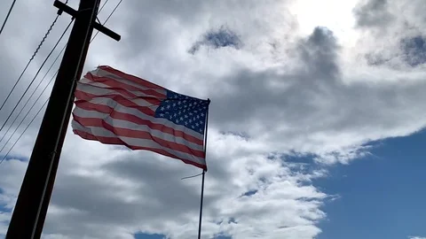 Slightly old American flag blowing in wind Stock Footage 125829357