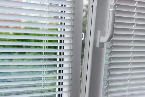Slightly open modern plastic window with horizontal blinds Stock Photos