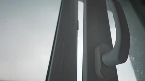 Slightly Open White Plastic Window Frame on a Cloudy Rainy Day Stock Footage 339175631