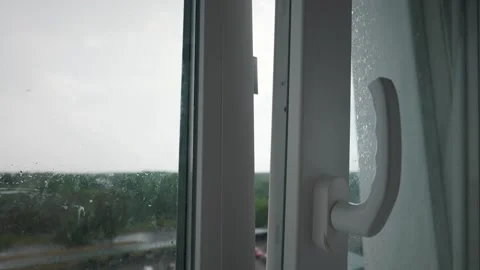 Slightly Open White Window Looking Out at Green Trees on Rainy Day Stock Footage 339176051