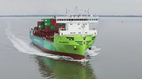 Slightly perspective green container ship eco maestro advancing through calm Stock Footage 328204566
