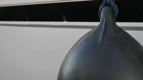 Slightly soiled spherical fender in partial view with a knotted rope Stock Footage 138693773