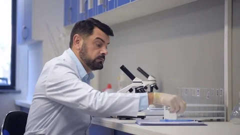 Slightly surprised researcher writing down his observations Stock Footage 80356056