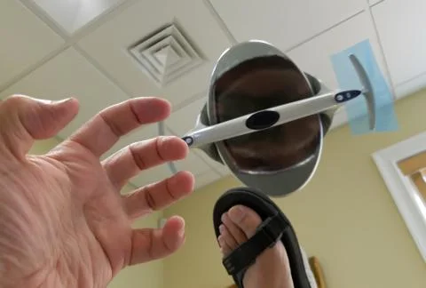 A slightly terrified patient going through the dreaded tooth drilling process Stock Photos