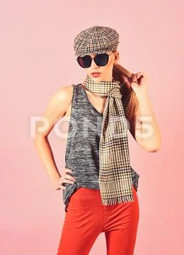 Slim blond model in tartan cap and scarf wearing big black sunglasses isolated Stock Photos