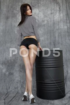 Slim brunette model in black lingerie Stock Photos
