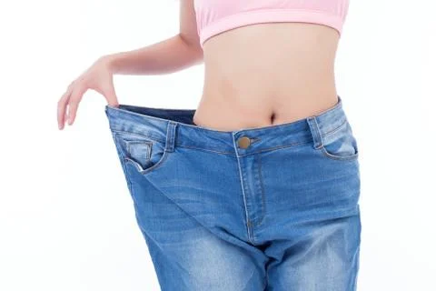 Slim fit woman in jeans, showing waistline, weight loss Stock Photos