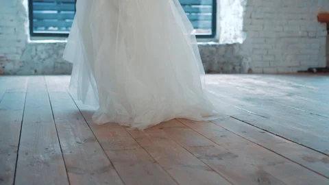 Slim, fragile lady gently steps on a wooden light floor to a large window, walks Stock Footage 100193368