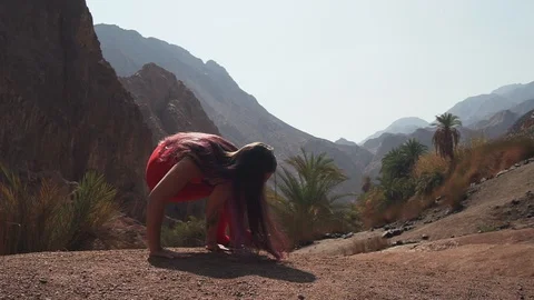 Slim girl practice side crane yoga pose at rocky haze nature slow motion Stock Footage 99071981