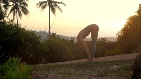 Slim lady does sun salutation yoga pose on track slow motion 스톡 동영상 112255886