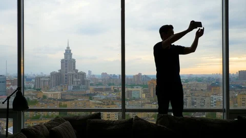 Slim man for a long time trying to take a selfie Stock Footage 103200195