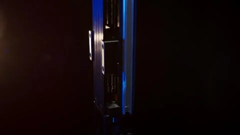 Slim Metallic Component in Blue Light, Dark Studio Background, Close Up Shot Stock Footage 341495120