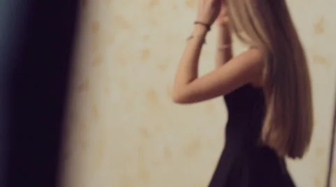 Slim model with long hair posing for a photographer at photo session Stock Footage 50363665