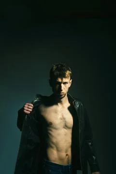 Slim thin torso of athletic man in leather jacket. Stock Photos