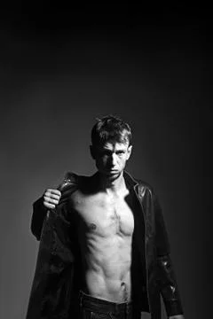 Slim thin torso of athletic man in leather jacket. Stock Photos