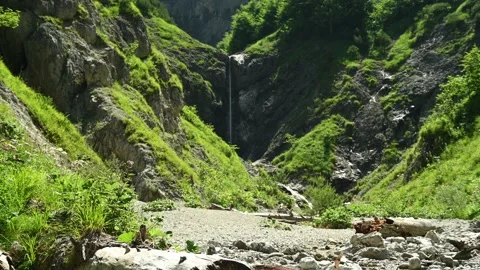 Slim waterfall and a small river in the mountains. Stock Footage 211499655