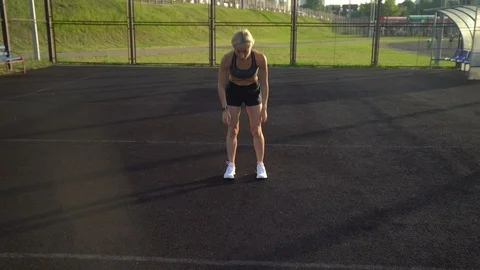 Slim woman doing push up exercise at sports ground Stock Footage 91550942