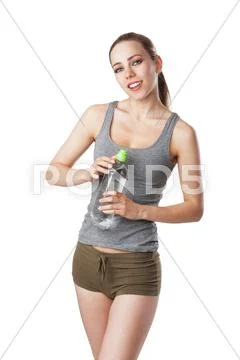 Slim woman in fitness dress holding a water bottle Stock Photos