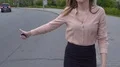 Slim young lady walking along road trying to catch ride to nearest car service HD Footage