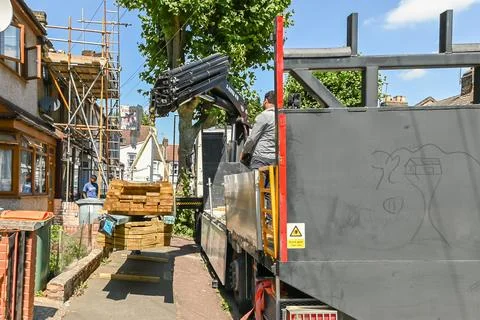 Slingers stack lumber loading on the roof Stock Photos