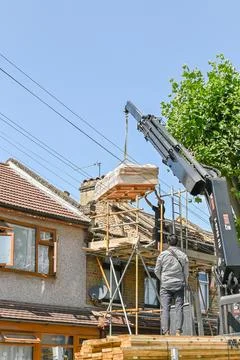Slingers stack lumber loading on the roof Stock Photos