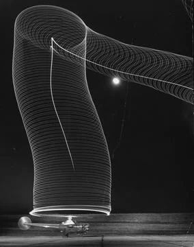 Slinky like light pattern in the blackness of moonlight sky produced by a time e Stock Photos
