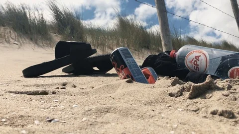 Slippers And Empty Cans At The Beach Stock Footage 111741014