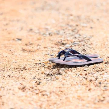 Slippers on the beach Stock Photos