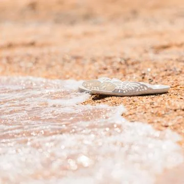 Slippers on the beach Stock Photos