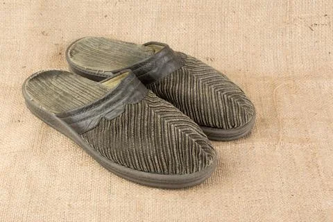 Slippers on burlap background Stock Photos