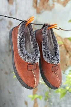Slippers hanging on a wire Stock Photos