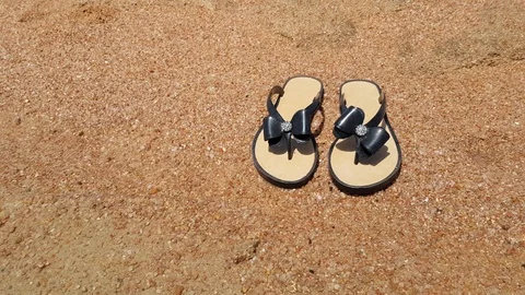 Slippers on the sand Stock Footage 107868761