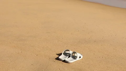 Slippers on a Sandy Beach 3 Video stock 134586217