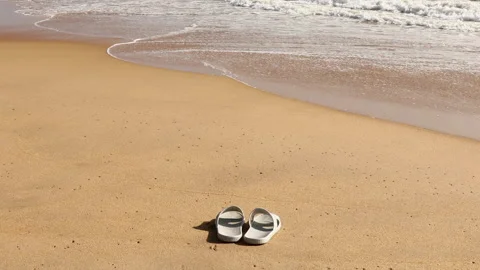 Slippers on a Sandy Beach Stock-Footage 134585507
