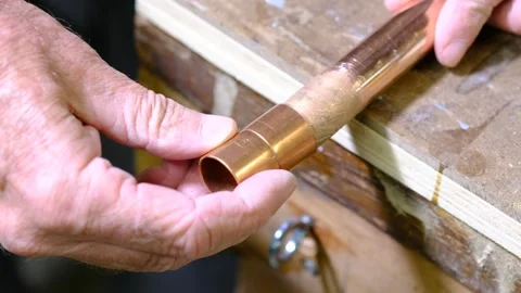 Slipping a fitting onto a copper pipe before soldering Stock Footage 139367598