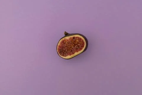 Slit figs on a purple background Stock Photos