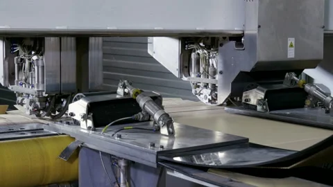 Slitting machine carves cardboard boxes from sheets of cardboard. 4K Stock Footage 168488567
