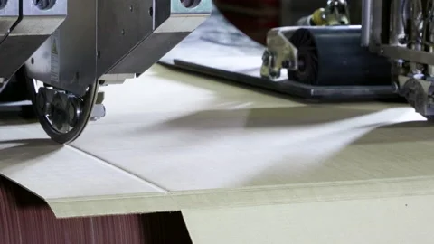 Slitting machine carves cardboard boxes from sheets of cardboard. 4K Stock Footage 172088340
