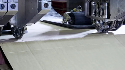 Slitting machine carves cardboard boxes from sheets of cardboard. 4K Stock Footage 205730300