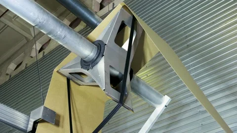 Slitting machine carves cardboard boxes from sheets of cardboard. 4K Stock Footage 209671746
