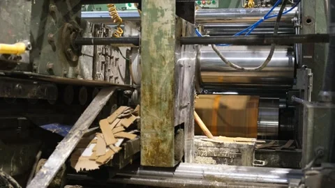Slitting machine carves cardboard boxes from sheets of cardboard. close up Stock-Footage 256596020
