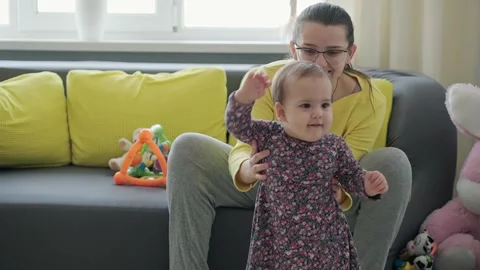 Slo-mo Authentic close up young neo caucasian mom play with infant child baby Stock Footage 149934211