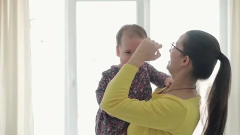 Slo-mo Authentic close up young neo caucasian mom play with infant child baby Stock Footage 150186642