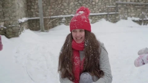 Slo-mo authentic cute happy young woman mom in red hat with children take snow Stock Footage 152879313