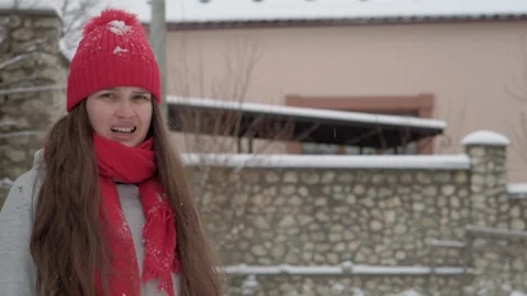 Slo-mo authentic happy cute young woman in red hat and scarf looking at camera Video stock 153227061