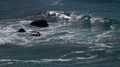 slo mo breaking wave coming in splashing up over rock HD Footage