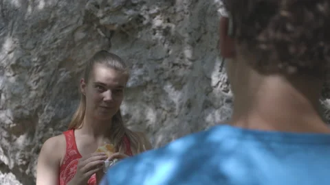 SLO MO Climbers taking a lunch break, eating and talking near the mountain  Stock Footage 208932182
