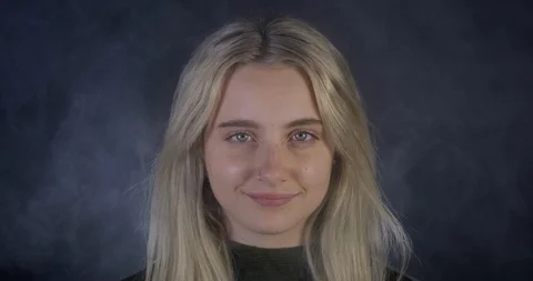 Slo-mo Close up of a Beautiful Blonde Model Smiling at the Camera With Blue Eyes Stock Footage 109210766