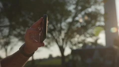 Slo mo close-up of man holding cell phone to take photo Stock Footage 252379512